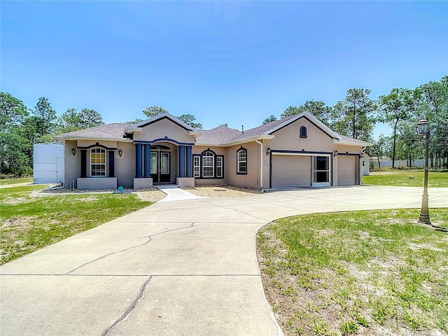 13110 Manistee Rd, Weeki Wachee, FL 34614 - view of front of house featuring stucco siding, an attached garage, concrete driveway, a front yard, and french doors