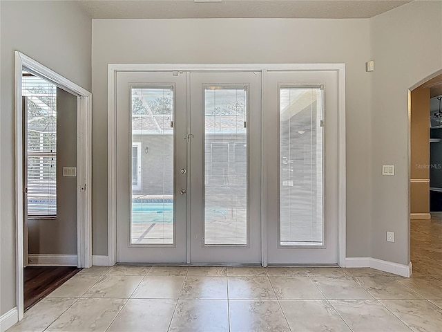 13110 Manistee Rd, Weeki Wachee, FL 34614 - doorway with french doors, arched walkways, and baseboards