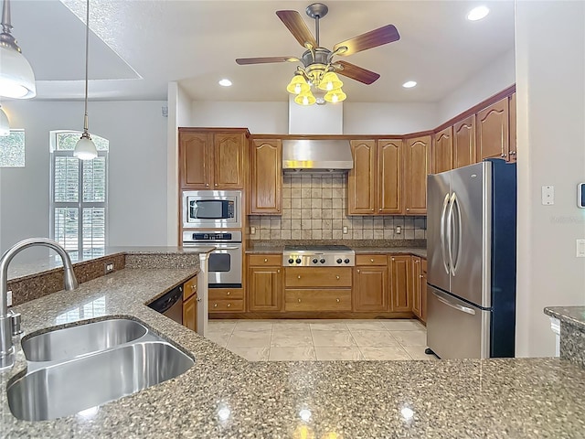 13110 Manistee Rd, Weeki Wachee, FL 34614 - kitchen featuring appliances with stainless steel finishes, a sink, backsplash, brown cabinetry, and recessed lighting