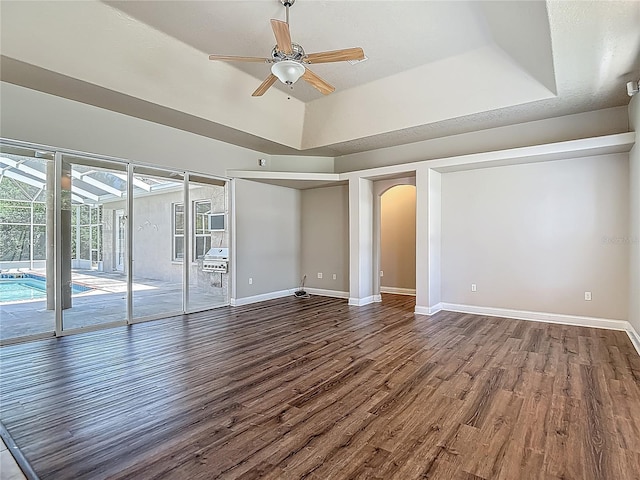 13110 Manistee Rd, Weeki Wachee, FL 34614 - empty room with ceiling fan, wood finished floors, arched walkways, and baseboards