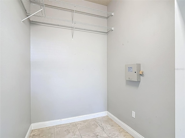 13110 Manistee Rd, Weeki Wachee, FL 34614 - laundry area featuring baseboards and light marble finish flooring
