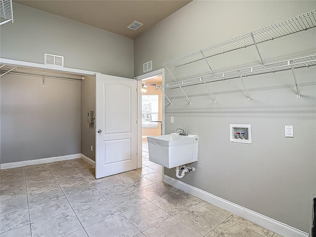 13110 Manistee Rd, Weeki Wachee, FL 34614 - laundry room with hookup for a washing machine and baseboards