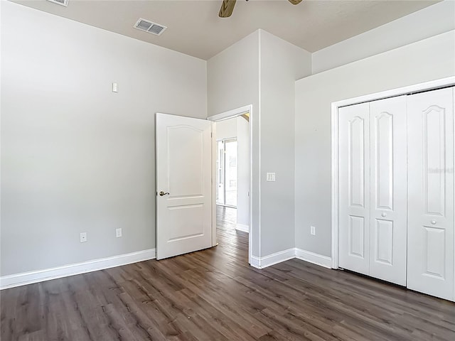 13110 Manistee Rd, Weeki Wachee, FL 34614 - unfurnished bedroom with dark wood-style floors, baseboards, and a closet