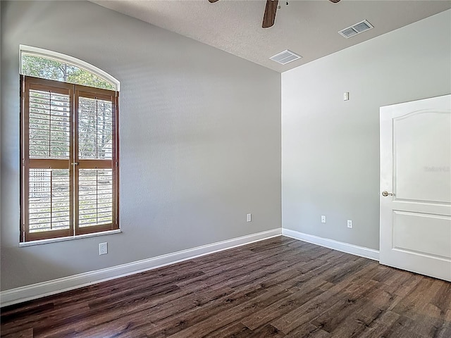 13110 Manistee Rd, Weeki Wachee, FL 34614 - empty room featuring dark wood-style flooring, ceiling fan, and baseboards