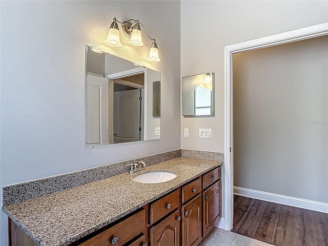 13110 Manistee Rd, Weeki Wachee, FL 34614 - bathroom with vanity, baseboards, and wood finished floors