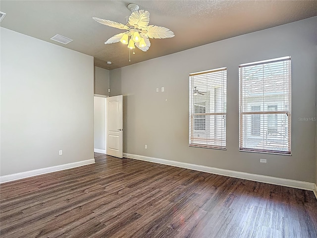 13110 Manistee Rd, Weeki Wachee, FL 34614 - empty room featuring dark wood-style flooring, baseboards, and a ceiling fan