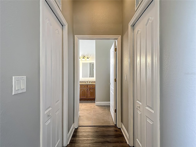 13110 Manistee Rd, Weeki Wachee, FL 34614 - corridor featuring dark wood-type flooring and baseboards