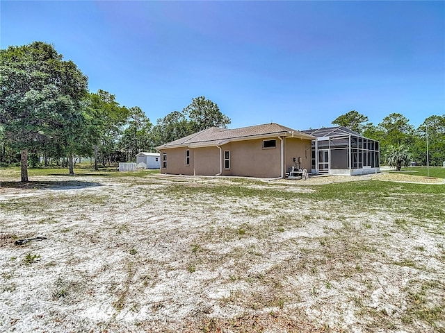 13110 Manistee Rd, Weeki Wachee, FL 34614 - view of side of property with stucco siding, a lanai, and a yard