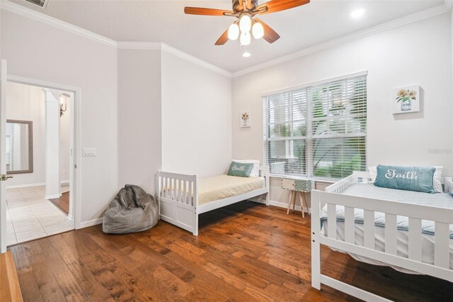 7410 Ambleside Dr, Land O Lakes, FL 34637 - bedroom with crown molding, wood finished floors, recessed lighting, baseboards, and ceiling fan