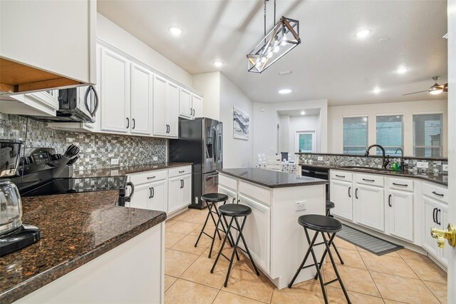 7410 Ambleside Dr, Land O Lakes, FL 34637 - kitchen featuring a sink, stainless steel appliances, decorative backsplash, white cabinetry, and recessed lighting