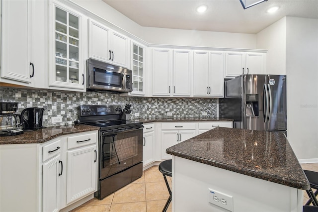 7410 Ambleside Dr, Land O Lakes, FL 34637 - kitchen featuring appliances with stainless steel finishes, backsplash, white cabinets, a center island, and recessed lighting