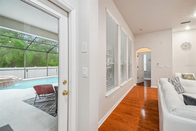 7410 Ambleside Dr, Land O Lakes, FL 34637 - hall featuring arched walkways, wood finished floors, and baseboards