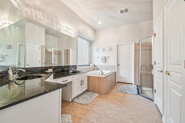 7410 Ambleside Dr, Land O Lakes, FL 34637 - full bath featuring a shower stall, a garden tub, vanity, and tile patterned flooring