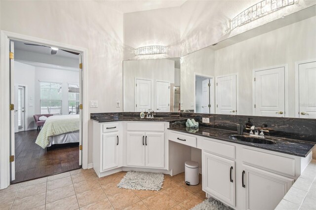7410 Ambleside Dr, Land O Lakes, FL 34637 - bathroom featuring a high ceiling, tile patterned floors, double vanity, and ensuite bath