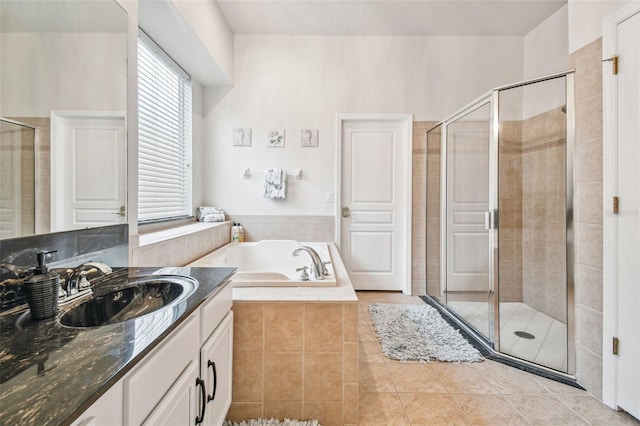 7410 Ambleside Dr, Land O Lakes, FL 34637 - full bathroom featuring a shower stall, a bath, vanity, and tile patterned floors