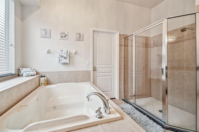 7410 Ambleside Dr, Land O Lakes, FL 34637 - full bath featuring a stall shower and a garden tub