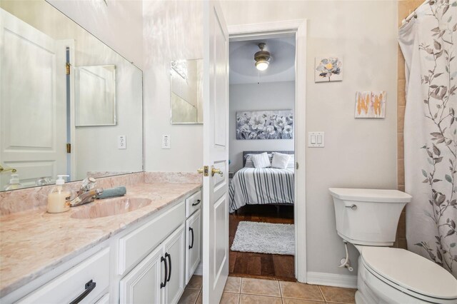 7410 Ambleside Dr, Land O Lakes, FL 34637 - full bathroom with toilet, tile patterned flooring, vanity, ensuite bathroom, and baseboards