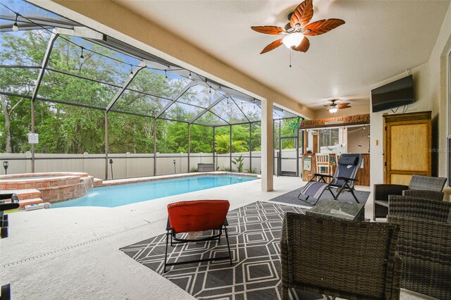 7410 Ambleside Dr, Land O Lakes, FL 34637 - view of swimming pool featuring a patio area, a pool with connected hot tub, a ceiling fan, and glass enclosure