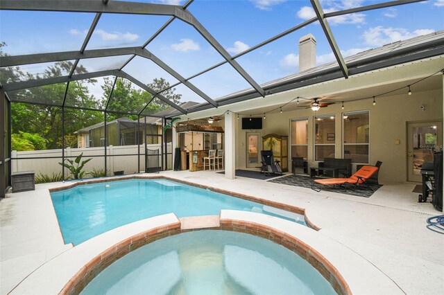 7410 Ambleside Dr, Land O Lakes, FL 34637 - view of pool featuring a patio, a ceiling fan, a pool with connected hot tub, and glass enclosure