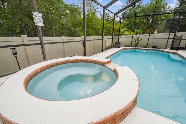 7410 Ambleside Dr, Land O Lakes, FL 34637 - view of pool featuring a pool with connected hot tub, glass enclosure, and fence