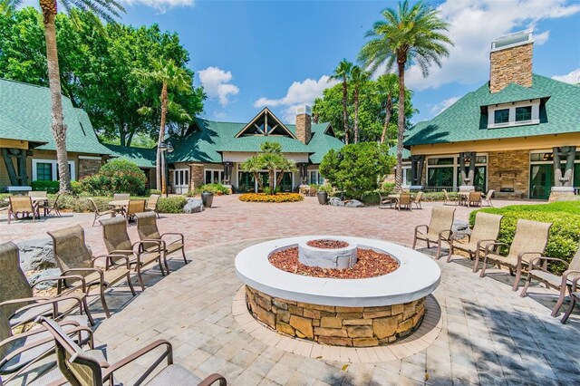 7410 Ambleside Dr, Land O Lakes, FL 34637 - view of patio / terrace with an outdoor fire pit