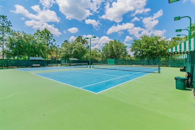 7410 Ambleside Dr, Land O Lakes, FL 34637 - view of tennis court featuring fence and community basketball court