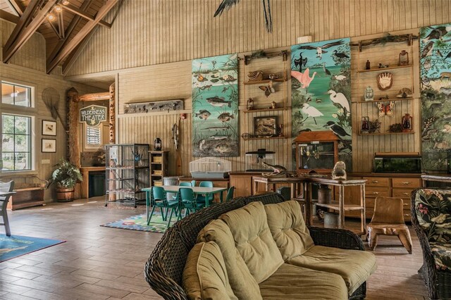 7410 Ambleside Dr, Land O Lakes, FL 34637 - living room with high vaulted ceiling, wood walls, beamed ceiling, and wood finished floors
