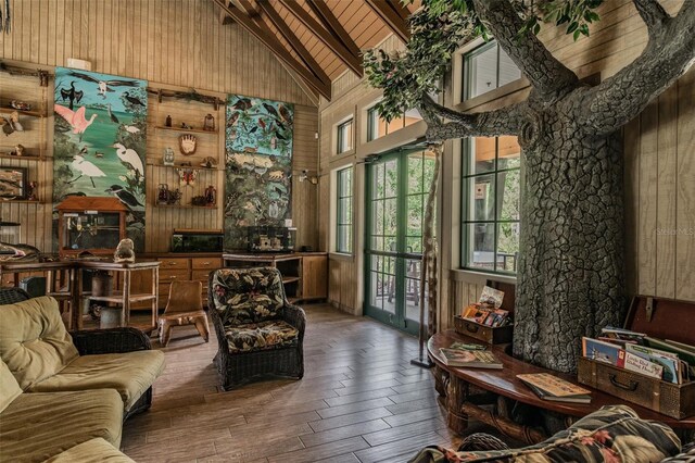 7410 Ambleside Dr, Land O Lakes, FL 34637 - living area with high vaulted ceiling, wood walls, beamed ceiling, wood-type flooring, and wooden ceiling