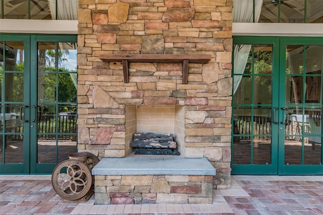 7410 Ambleside Dr, Land O Lakes, FL 34637 - detailed view of french doors and an outdoor stone fireplace