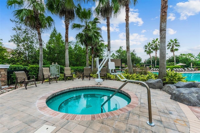7410 Ambleside Dr, Land O Lakes, FL 34637 - view of pool featuring a patio area, a pool, and a community hot tub