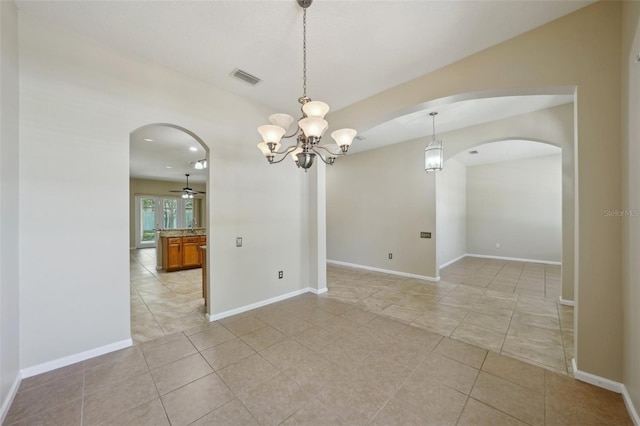 5340 Riva Ridge Dr, Wesley Chapel, FL 33544 - spare room featuring arched walkways, light tile patterned flooring, ceiling fan, a chandelier, and baseboards