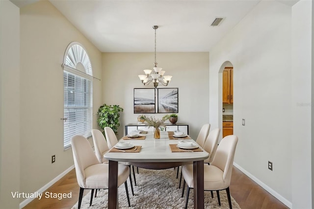 5340 Riva Ridge Dr, Wesley Chapel, FL 33544 - dining area with arched walkways, baseboards, and wood finished floors