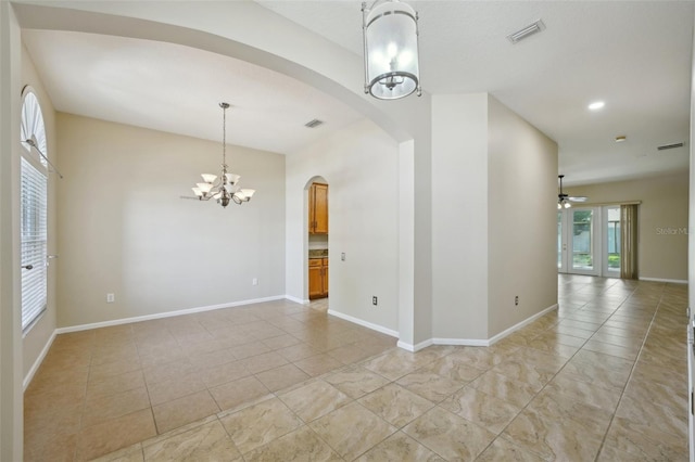 5340 Riva Ridge Dr, Wesley Chapel, FL 33544 - unfurnished room featuring a chandelier, arched walkways, a ceiling fan, and light tile patterned floors