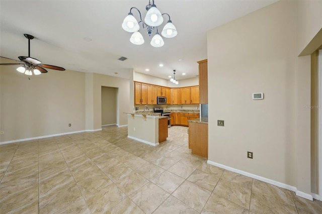 5340 Riva Ridge Dr, Wesley Chapel, FL 33544 - kitchen with stainless steel appliances, ceiling fan, open floor plan, a breakfast bar, and a chandelier