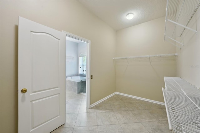 5340 Riva Ridge Dr, Wesley Chapel, FL 33544 - spacious closet featuring light tile patterned floors