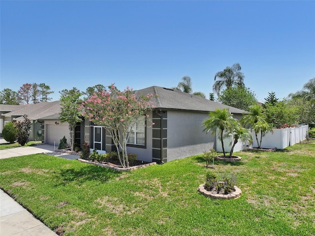 5340 Riva Ridge Dr, Wesley Chapel, FL 33544 - view of property exterior featuring a garage, stucco siding, a yard, and driveway