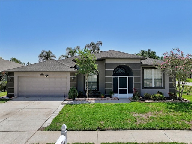 5340 Riva Ridge Dr, Wesley Chapel, FL 33544 - ranch-style house featuring a garage, a front yard, concrete driveway, stucco siding, and roof with shingles