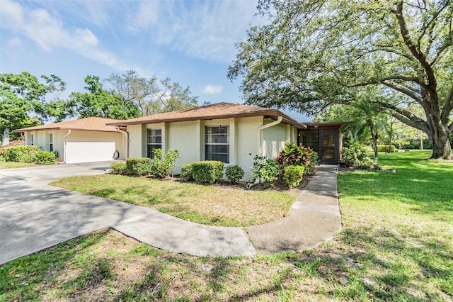2150 Shelly Dr Unit D, Palm Harbor, FL 34684 - ranch-style home with stucco siding, a garage, a front lawn, and concrete driveway