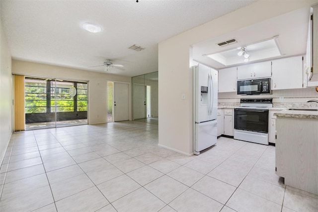 2150 Shelly Dr Unit D, Palm Harbor, FL 34684 - kitchen featuring white appliances, open floor plan, a tray ceiling, light tile patterned floors, and ceiling fan