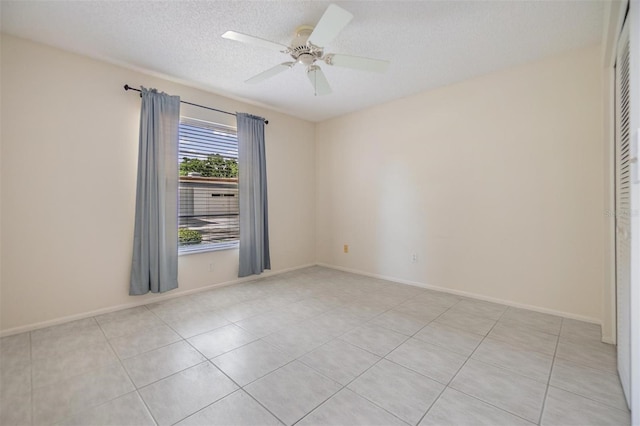 2150 Shelly Dr Unit D, Palm Harbor, FL 34684 - tiled spare room featuring ceiling fan, a textured ceiling, and baseboards