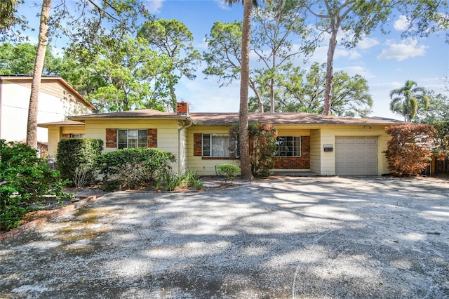 4711 W Vasconia St, Tampa, FL 33629 - single story home with a chimney, an attached garage, and driveway