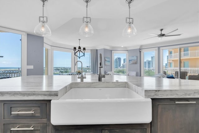 555 5th Ave NE Unit 1032, Saint Petersburg, FL 33701 - kitchen featuring a sink, light stone countertops, and plenty of natural light