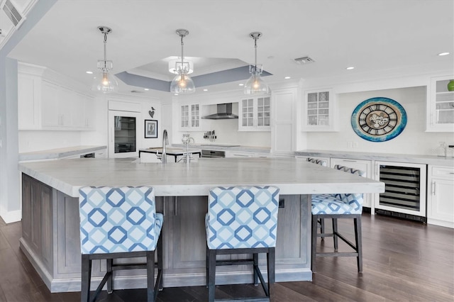555 5th Ave NE Unit 1032, Saint Petersburg, FL 33701 - kitchen with wine cooler, wall chimney range hood, dark wood-style flooring, white cabinetry, and recessed lighting