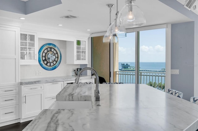555 5th Ave NE Unit 1032, Saint Petersburg, FL 33701 - kitchen with white cabinetry, a sink, a water view, and recessed lighting