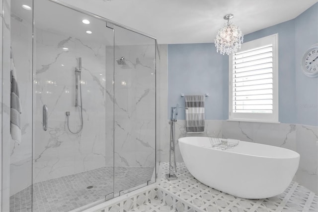 555 5th Ave NE Unit 1032, Saint Petersburg, FL 33701 - full bathroom with a marble finish shower, a freestanding tub, a chandelier, tile walls, and recessed lighting