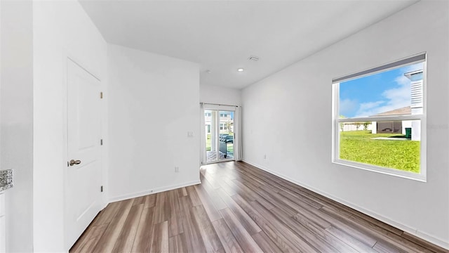 35552 Shade Fern Ln, Zephyrhills, FL 33541 - unfurnished room with wood finished floors, baseboards, and recessed lighting