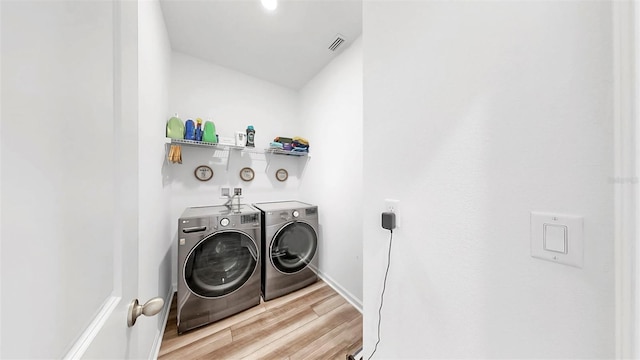 35552 Shade Fern Ln, Zephyrhills, FL 33541 - laundry room featuring separate washer and dryer and light wood finished floors