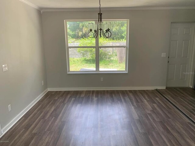 808 Hillsdale Dr, Cocoa, FL 32922 - unfurnished dining area with a chandelier, plenty of natural light, dark wood-style flooring, baseboards, and ornamental molding