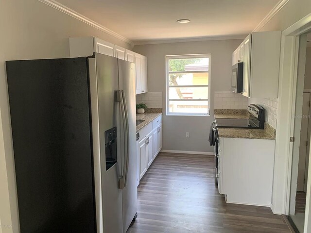 808 Hillsdale Dr, Cocoa, FL 32922 - kitchen with appliances with stainless steel finishes, ornamental molding, white cabinetry, backsplash, and dark wood-type flooring