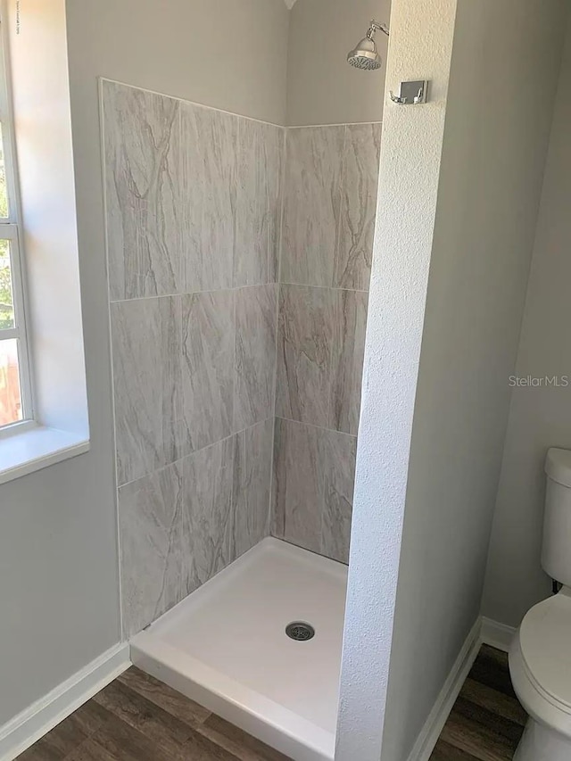 808 Hillsdale Dr, Cocoa, FL 32922 - bathroom with toilet, a stall shower, baseboards, and wood finished floors